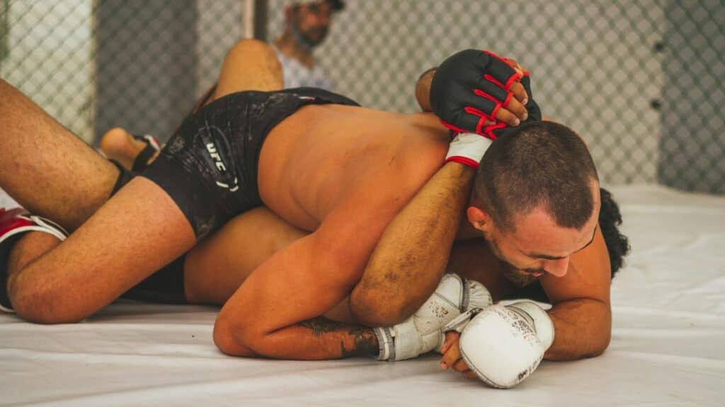 One fighter is using grappling technique over other